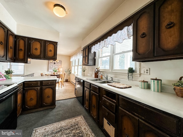 kitchen featuring black dishwasher, light countertops, a sink, and electric stove