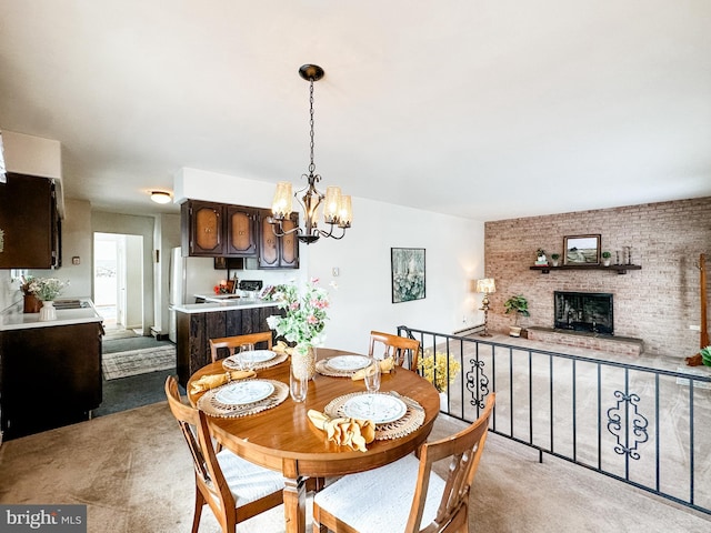 dining room with a brick fireplace and an inviting chandelier