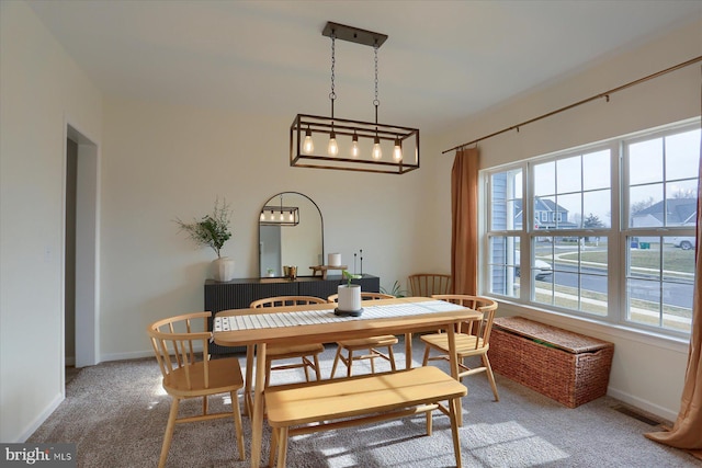 dining area with carpet and a wealth of natural light