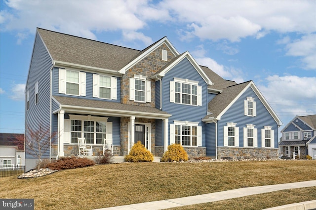 craftsman-style house with covered porch and a front lawn