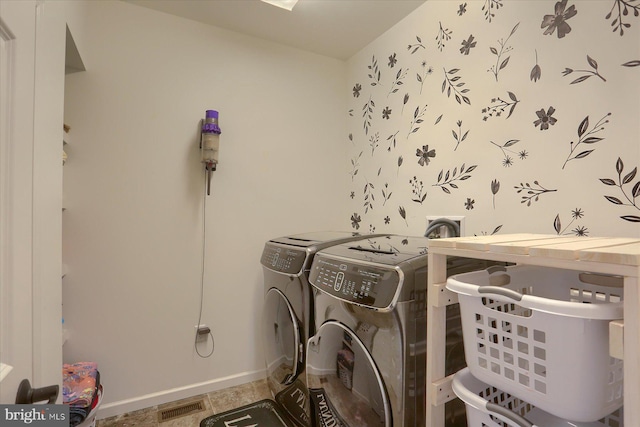 clothes washing area featuring washer and dryer