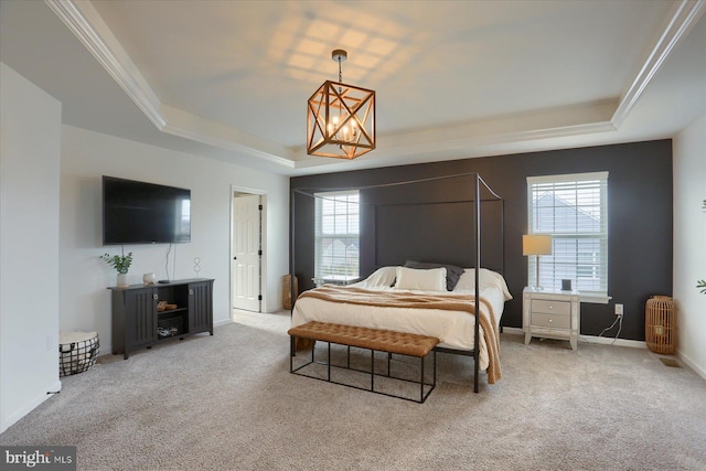 bedroom with multiple windows, carpet floors, and a tray ceiling