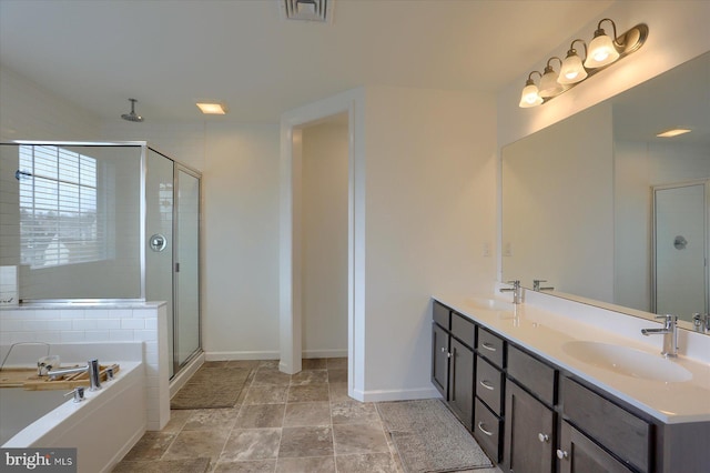 bathroom with vanity and independent shower and bath