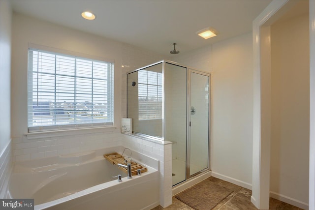 bathroom with independent shower and bath and tile patterned flooring