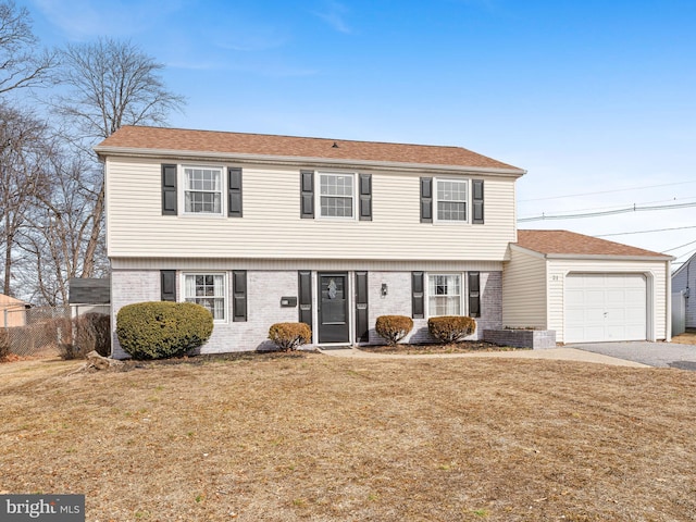 view of front of house featuring a garage and a front lawn