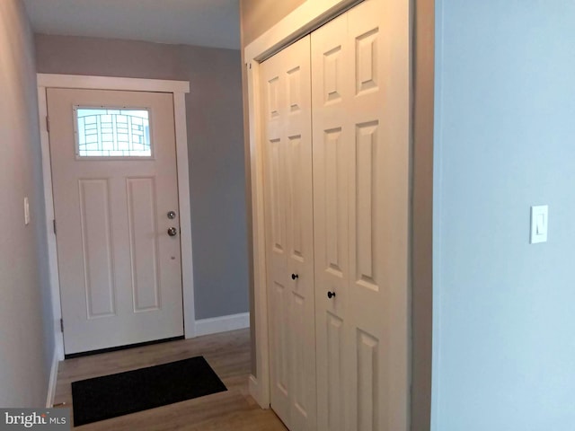 foyer featuring light wood-type flooring and baseboards