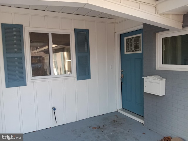 view of exterior entry featuring board and batten siding