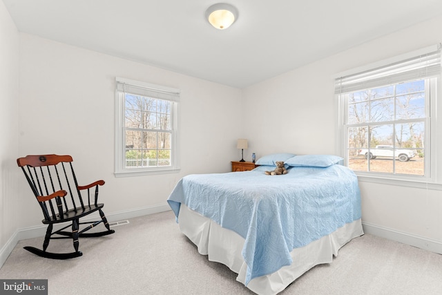 bedroom with baseboards and carpet