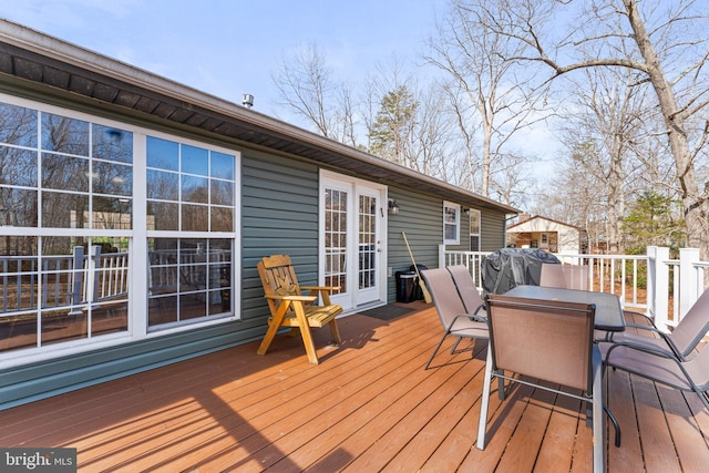 wooden terrace featuring outdoor dining space