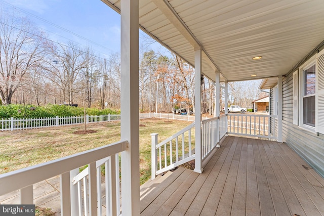 deck with a porch, a yard, and fence