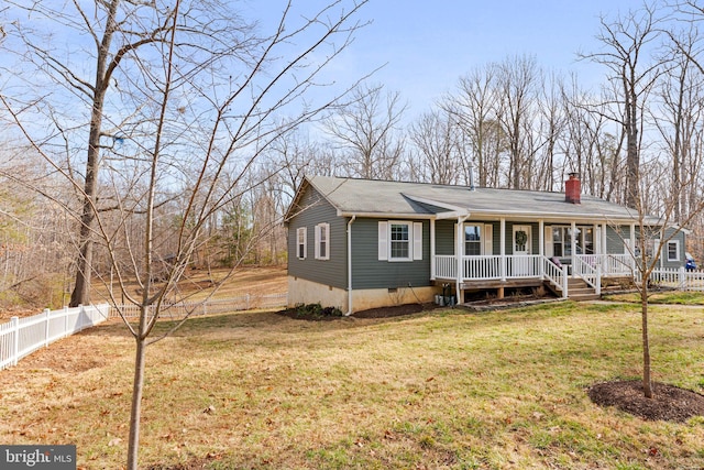 view of front of home with a front lawn, fence, covered porch, a chimney, and crawl space