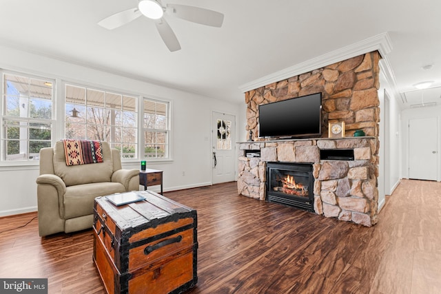 living area featuring plenty of natural light, attic access, wood finished floors, and ornamental molding