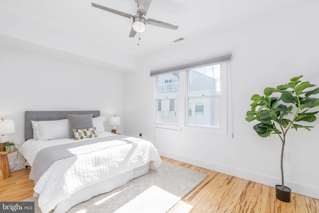 bedroom with hardwood / wood-style flooring and ceiling fan