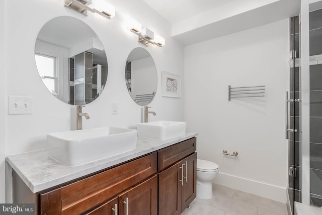 bathroom with vanity, toilet, a shower with shower door, and tile patterned flooring