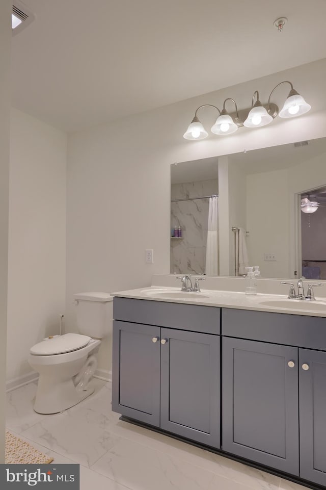 bathroom featuring vanity, toilet, and walk in shower