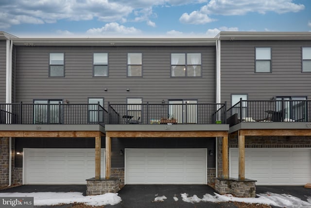 snow covered property featuring a garage