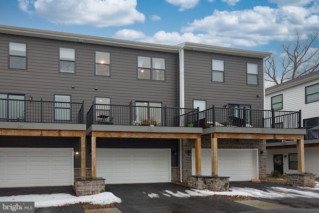 rear view of property featuring a garage