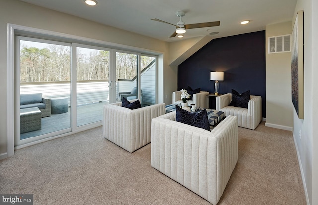 carpeted living room with ceiling fan