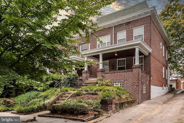 208 E 32nd St, Baltimore, MD 21218 - view of front of property with stairs, a porch, and brick siding