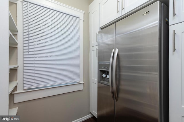 kitchen featuring open shelves, white cabinetry, and stainless steel refrigerator with ice dispenser