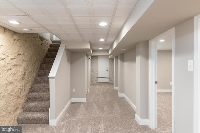 finished basement with carpet, stairs, baseboards, and recessed lighting