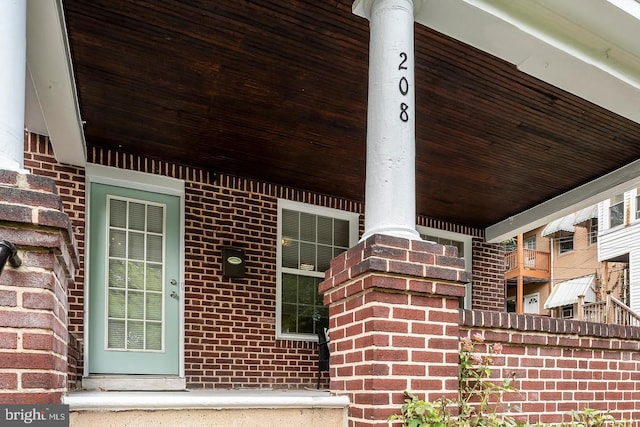 entrance to property with brick siding