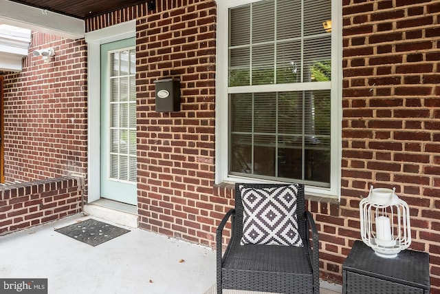 entrance to property featuring brick siding