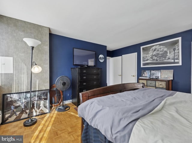 bedroom featuring parquet flooring