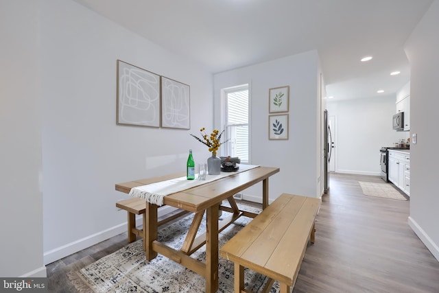 dining area featuring baseboards, dark wood-style flooring, and recessed lighting