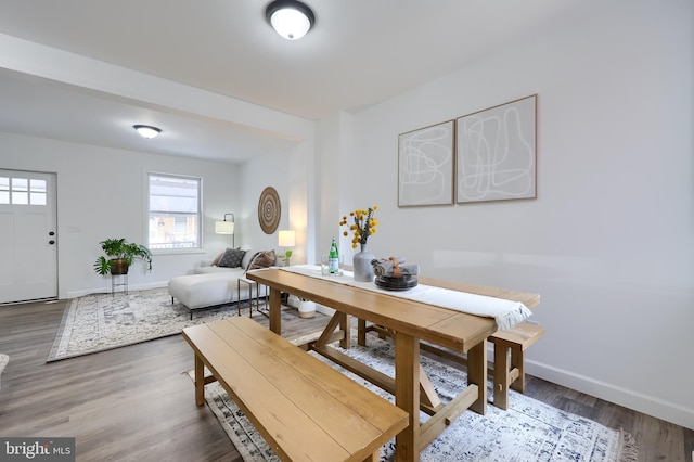 dining area featuring dark wood finished floors and baseboards