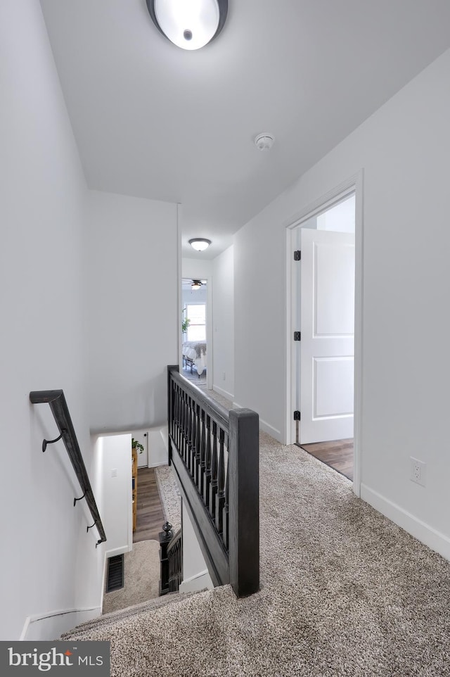 stairs with carpet floors and baseboards