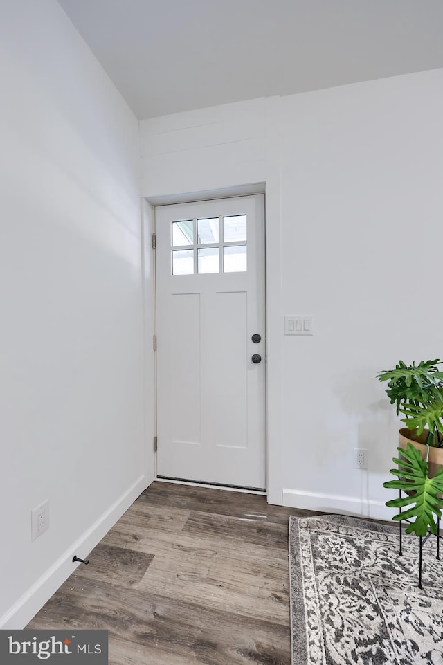 entryway with wood finished floors and baseboards