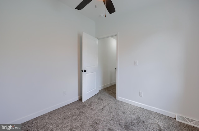 unfurnished bedroom with a ceiling fan, light colored carpet, visible vents, and baseboards