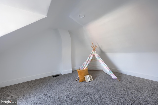 recreation room featuring lofted ceiling, carpet floors, baseboards, and visible vents