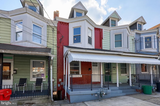 townhome / multi-family property featuring board and batten siding and covered porch