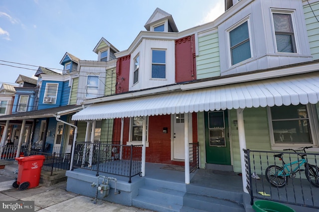 townhome / multi-family property featuring board and batten siding and covered porch