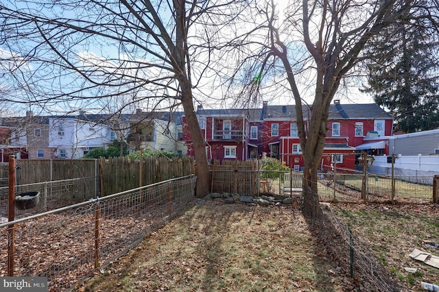 view of yard featuring a residential view and fence