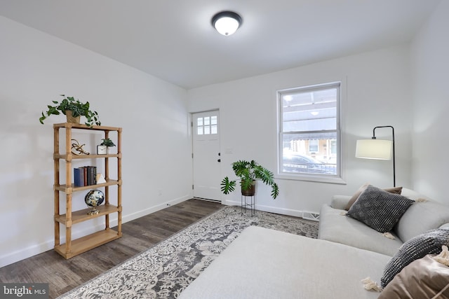 entryway with dark wood finished floors, visible vents, and baseboards