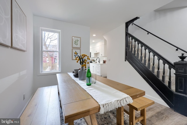 dining space with baseboards, stairway, recessed lighting, and light wood-style floors