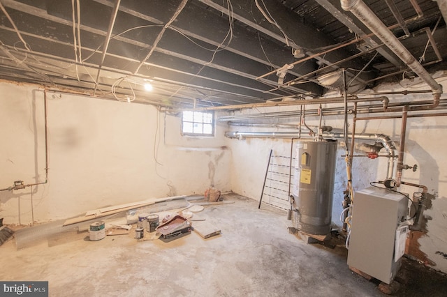 basement featuring water heater and a heating unit