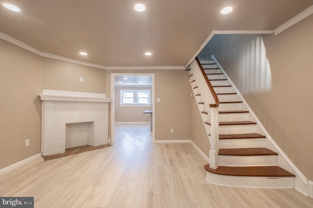 unfurnished living room featuring crown molding, baseboards, stairs, recessed lighting, and wood finished floors