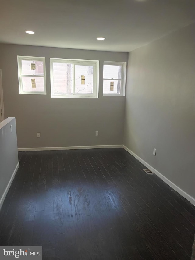 spare room with dark hardwood / wood-style flooring