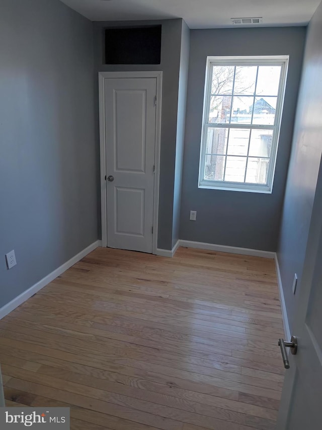 unfurnished room with light wood-type flooring