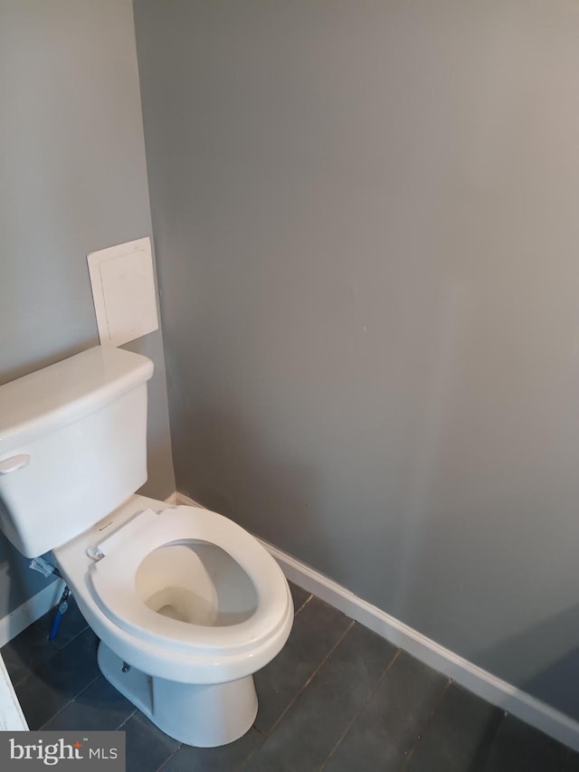 bathroom featuring toilet and tile patterned flooring