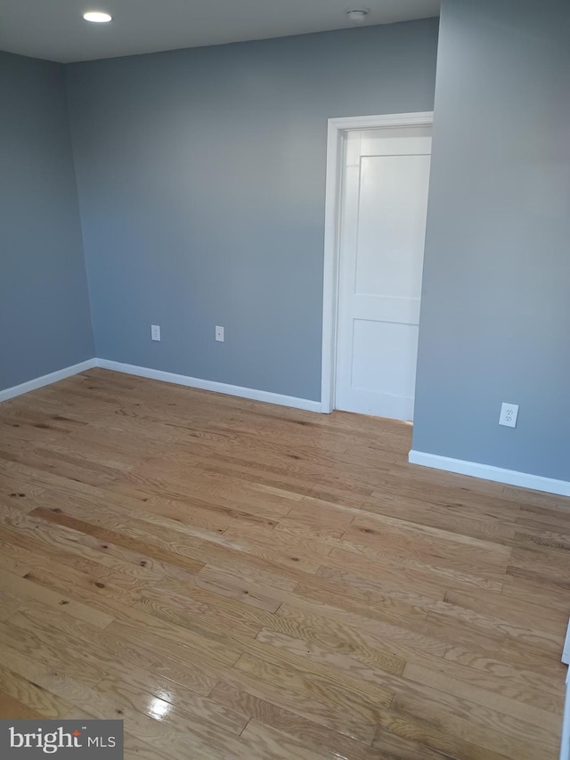 unfurnished room with light wood-type flooring