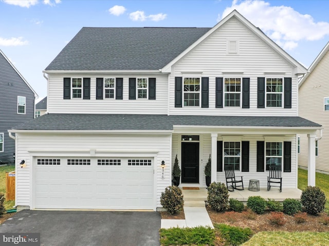 view of front of house featuring a garage and a porch