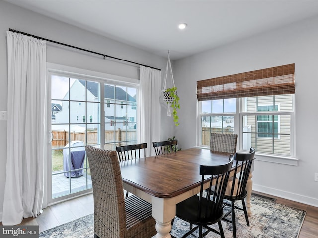 dining space featuring hardwood / wood-style floors and a healthy amount of sunlight