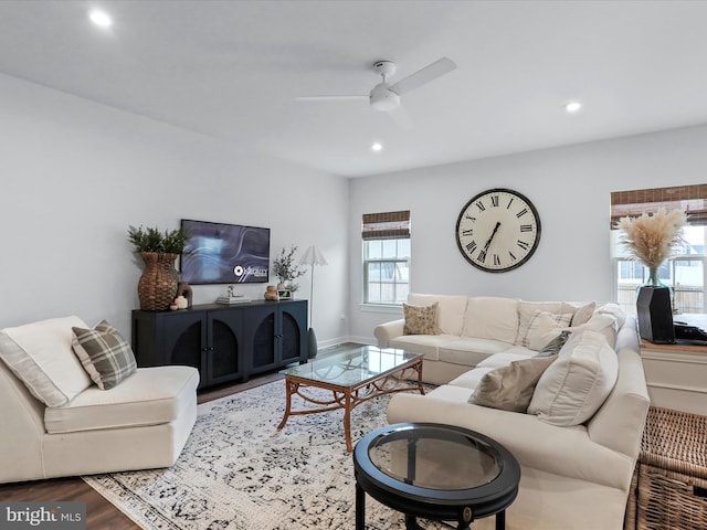 living room featuring hardwood / wood-style floors and ceiling fan