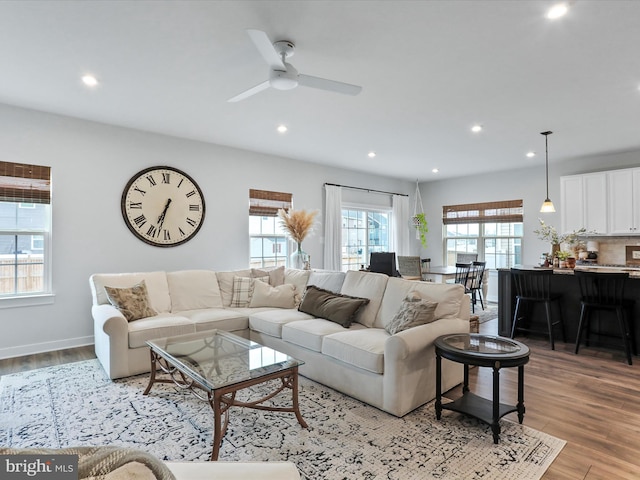 living room featuring light hardwood / wood-style floors and ceiling fan