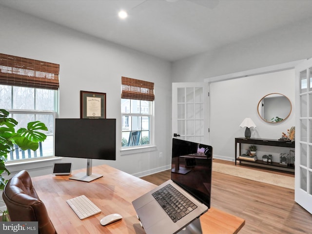 office featuring hardwood / wood-style flooring and french doors